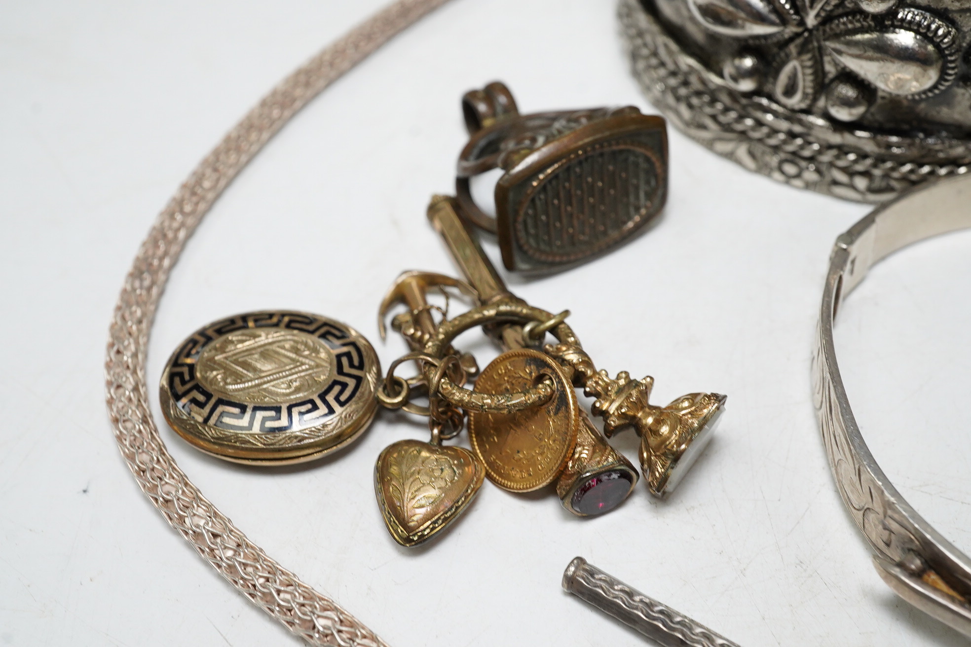 A small quantity of assorted costume jewellery including a fob seal and a one dollar gold charm. Condition - fair to good